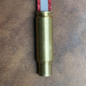 LAPre 8.6 Blackout modified case threaded onto a red Hornady Lock-N-Load overall length OAL gauge tool