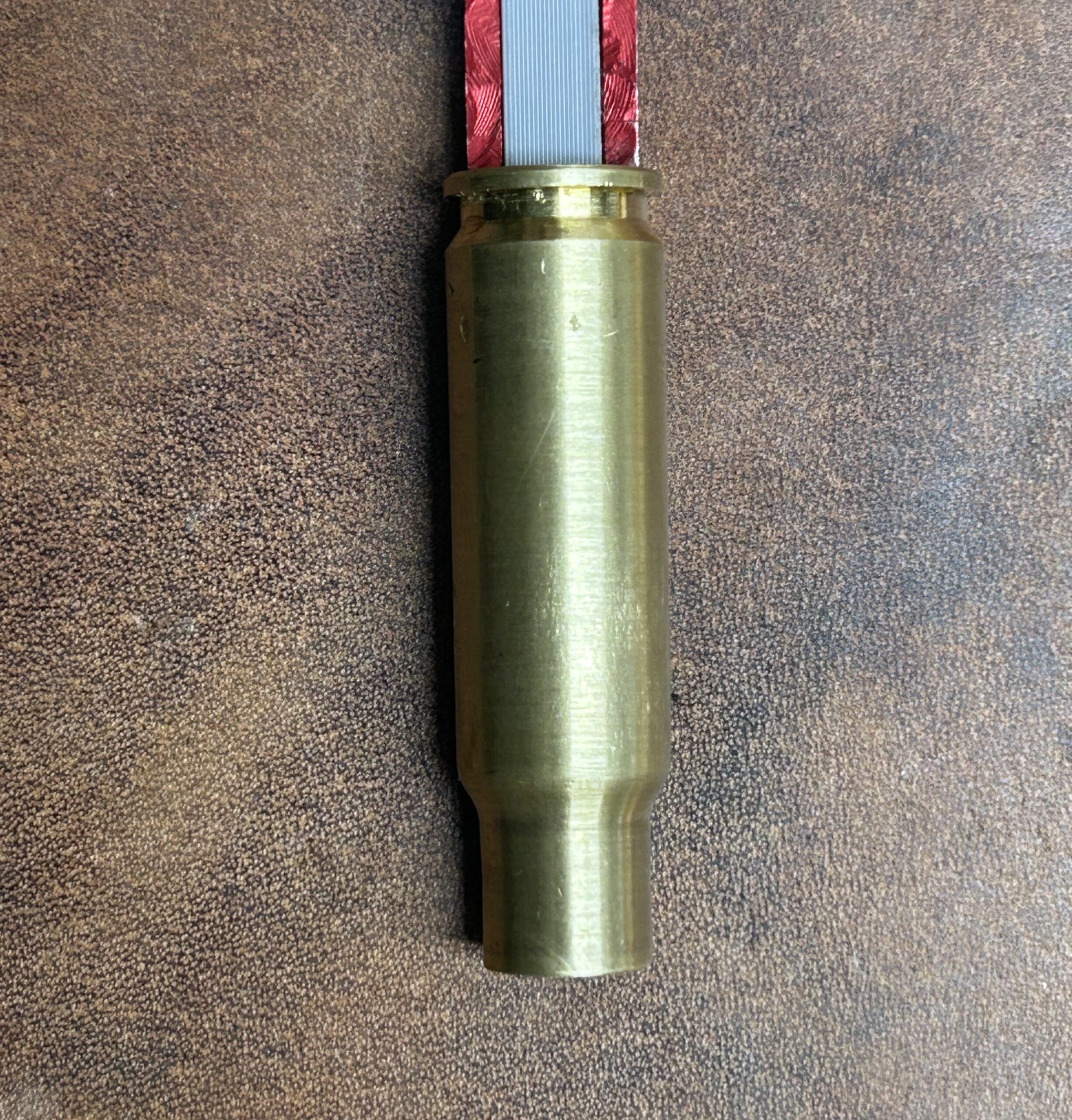 LAPre 8.6 Blackout modified case threaded onto a red Hornady Lock-N-Load overall length OAL gauge tool